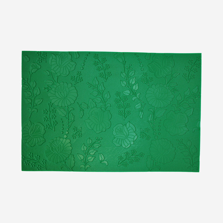 Textured mat that has a floral pattern.