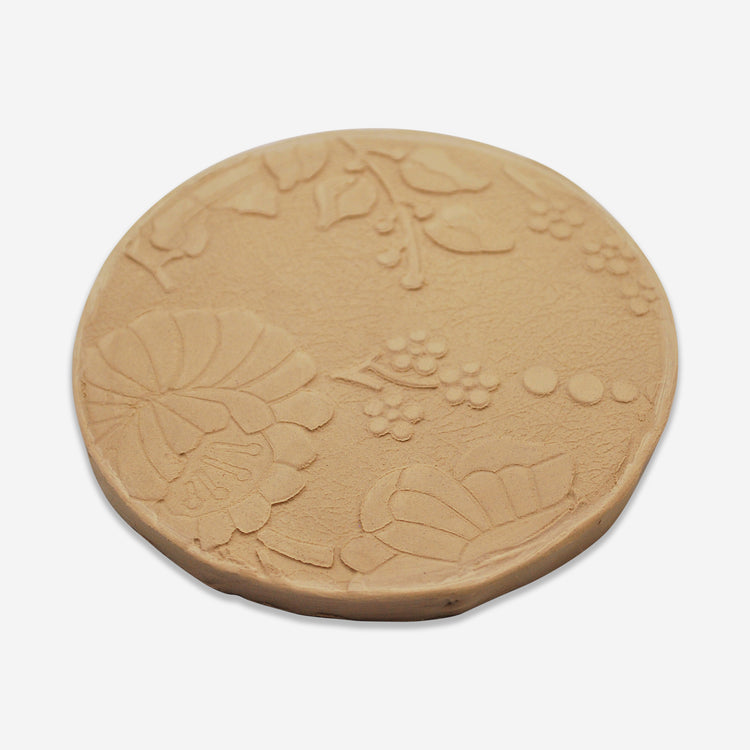 Textured mat that has a floral pattern.