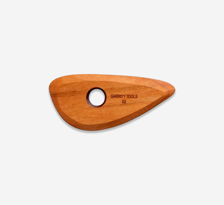 B2 is a small curvy tool with no sharp edges. It's perfect for smoothing
the sides or inside of a vessel and creating distinct curves and facets
in your work.