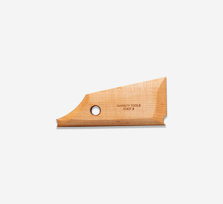Foot 8 features a simple curve that leads into the footing tool on one end
and a taller straight edge with a footing tool on the other end.