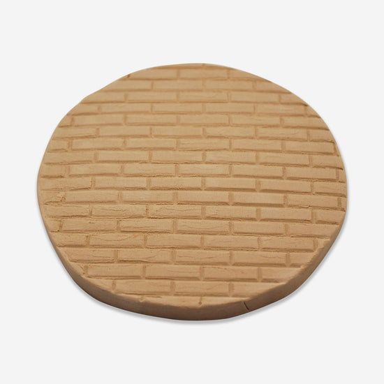 Textured mat that has a brick pattern.