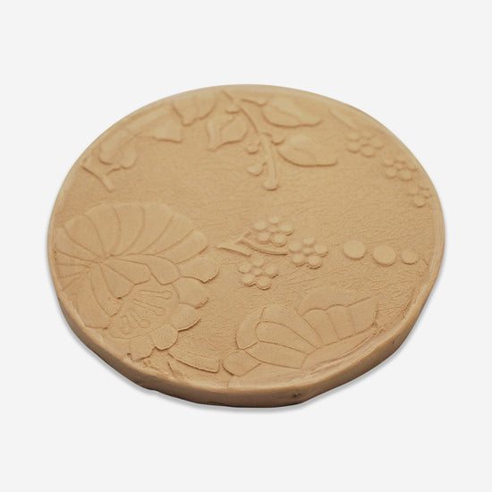 Textured mat that has a floral pattern.