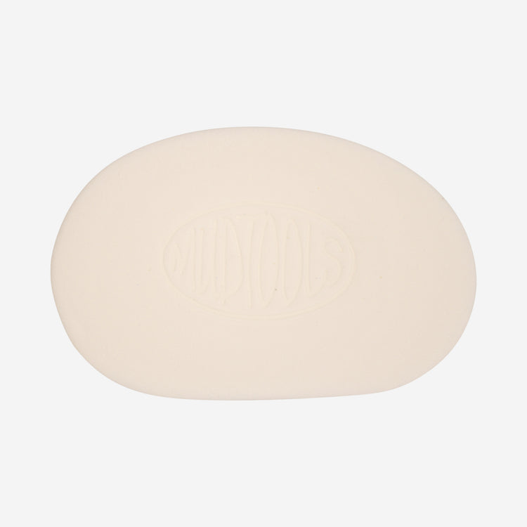White mudsponge is a less absorbant synthetic sponge shaped like a potters rib that is used for finishing up final details on greenware.